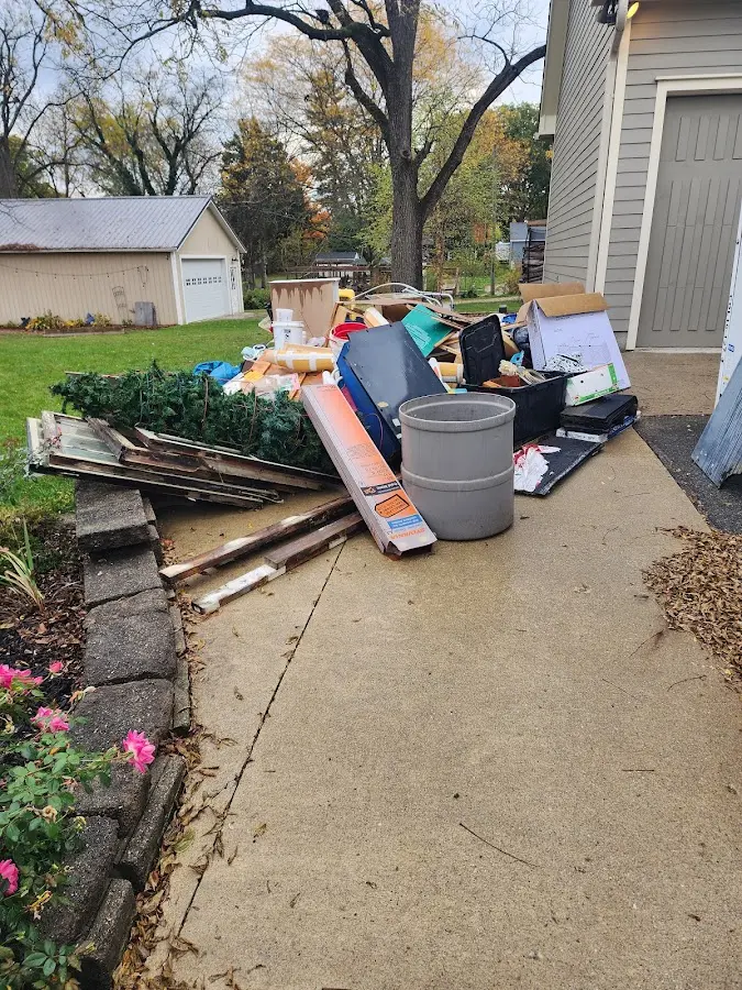 Dumpster being loaded with debris for Estate Cleanout Dumpster Rental in Smithville-Sanders